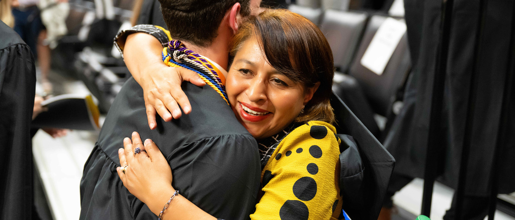 Gabriela Rivera hugs student graduating